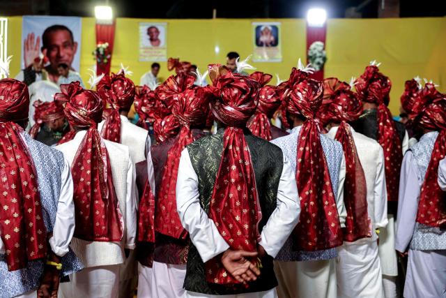 Grooms wait to get married during a mass wedding ceremony in Varanasi on May 1, 2026. (Photo by Niharika KULKARNI / AFP)