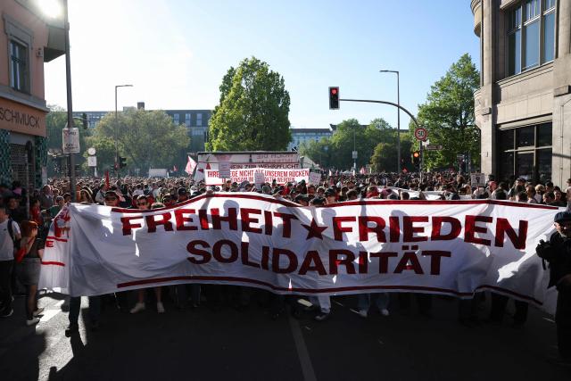 Participants display a banner reading 'Freedom, Peace, Solidarity' as they march from Oranienplatz Square in Berlin's Kreuzberg district on May 1, 2026 during the annual leftist May Day demonstration in the German capital. (Photo by Odd ANDERSEN / AFP)