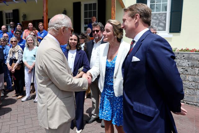 Britain's King Charles III speaks with Claire Larner (C) and Former assistant equerry James Larner during a visit to the Bermuda Aquarium Museum on May 01, 2026 in Hamilton, Bermuda. King Charles III is in Bermuda for his first visit to a British Overseas Territory as Sovereign. (Photo by Chris Jackson / POOL / AFP)