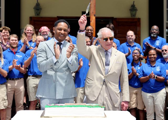 Britain's King Charles III cuts a cake to mark the centenary of the Bermuda Aquarium Museum during a visit to the Bermuda Aquarium Museum on May 1, 2026 in Hamilton, Bermuda. King Charles III is in Bermuda for his first visit to a British Overseas Territory as Sovereign. (Photo by Chris Jackson / POOL / AFP)