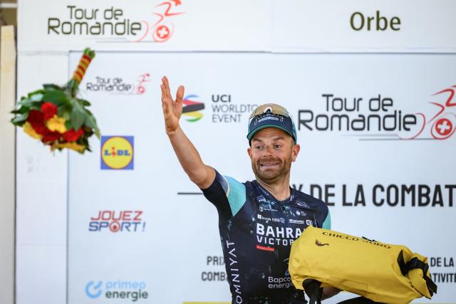 Bahrain Victorious’ Italian rider Damiano Caruso awarded as best fighter throws flowers during the podium ceremony of the third stage of the Tour of Romandie UCI cycling World tour, a 176.6 km loop departing and arriving in Orbe, Switzerland, on May, 1, 2026. (Photo by Fabrice COFFRINI / AFP)