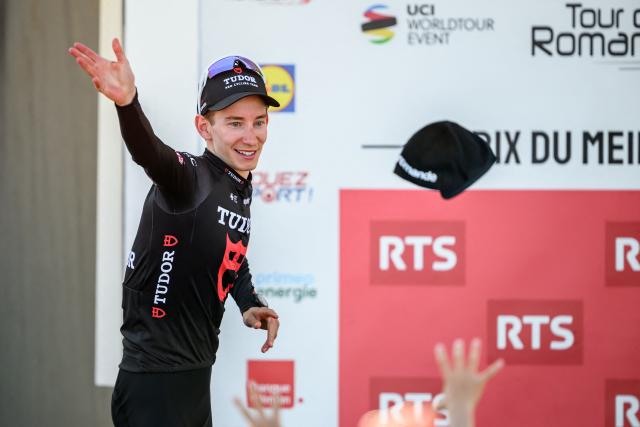 Tudor Pro Cycling Team’s Swiss rider Yannis Voisard awarded as best Swiss of the race throws a cap during the podium ceremony of the third stage of the Tour of Romandie UCI cycling World tour, a 176.6 km loop departing and arriving in Orbe, Switzerland, on May, 1, 2026. (Photo by Fabrice COFFRINI / AFP)