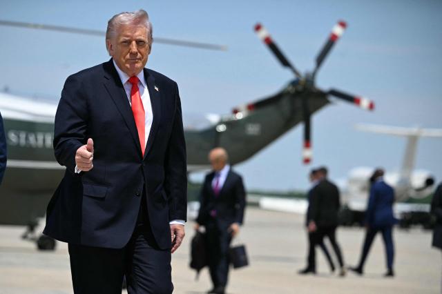 US President Donald Trump flashes a thumbs up while walking to board Air Force One at Joint Base Andrews, Maryland on May 1, 2026. Trump is going to Florida to speak at an event at The Villages and to attend the Forum Club of the Palm Beaches dinner. (Photo by Jim WATSON / AFP)