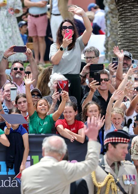 Britain's King Charles III waves to the crowd at the Royal Bermuda Yacht Club in Hamilton, Bermuda, on May 1, 2026. King Charles III is in Bermuda for his first visit to a British Overseas Territory as Sovereign. (Photo by Chris Jackson / POOL / AFP)