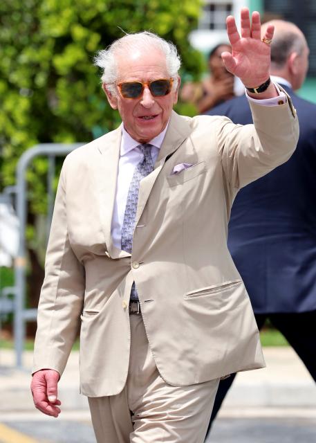 Britain's King Charles III waves to the crowd at the Royal Bermuda Yacht Club in Hamilton, Bermuda, on May 1, 2026. King Charles III is in Bermuda for his first visit to a British Overseas Territory as Sovereign. (Photo by Chris Jackson / POOL / AFP)