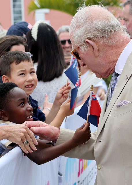 Britain's King Charles III greets children at the Royal Bermuda Yacht Club in Hamilton, Bermuda, on May 1, 2026. King Charles III is in Bermuda for his first visit to a British Overseas Territory as Sovereign. (Photo by Chris Jackson / POOL / AFP)