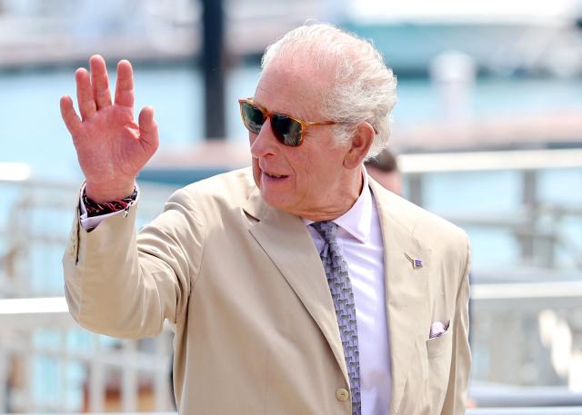 Britain's King Charles III waves as he departs from a ferry crossing on May 1, 2026 in Hamilton, Bermuda. King Charles III is in Bermuda for his first visit to a British Overseas Territory as Sovereign. (Photo by Chris Jackson / POOL / AFP)