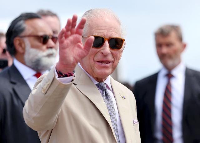 Britain's King Charles III waves as he departs from a ferry crossing on May 1, 2026 in Hamilton, Bermuda. King Charles III is in Bermuda for his first visit to a British Overseas Territory as Sovereign. (Photo by Chris Jackson / POOL / AFP)