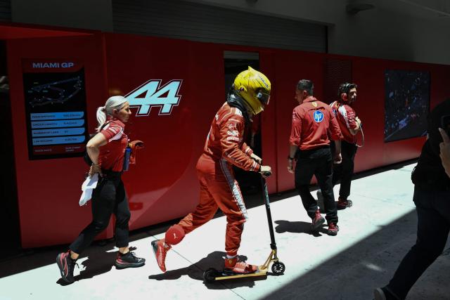 Ferrari's British driver Lewis Hamilton rides a scooter as he leaves the garage following a practice session for the 2026 Miami Formula One Grand Prix at Miami International Autodrome in Miami Gardens, Florida, on May 1, 2026. (Photo by CHANDAN KHANNA / AFP)