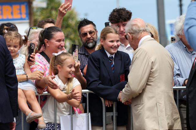 Britain's King Charles greets supporters, as he arrives in Sandys Parish, in Bermuda, on May 1, 2026. King Charles III is in Bermuda for his first visit to a British Overseas Territory as Sovereign. (Photo by Suzanne Plunkett / POOL / AFP)