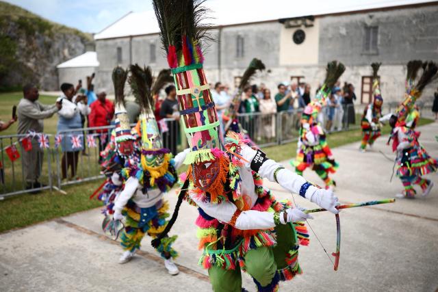 Gombey dancers perform during a cultural welcome for Britain's King Charles III at the Royal Naval Dockyard, Sandys Parish, Bermuda on May 1, 2026. King Charles III is in Bermuda for his first visit to a British Overseas Territory as Sovereign. (Photo by HENRY NICHOLLS / AFP)