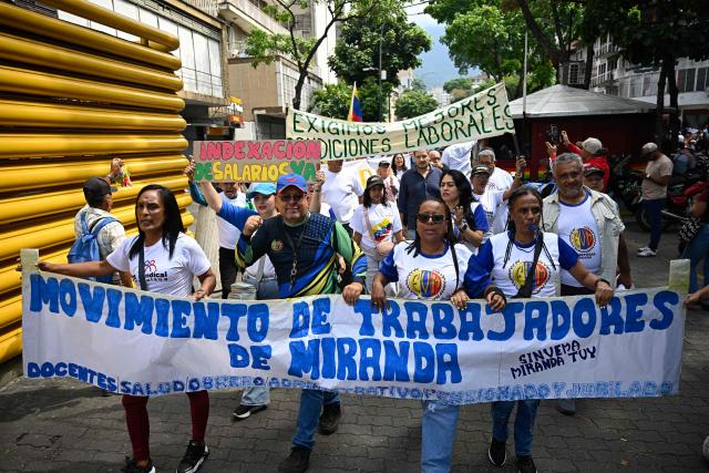 Demonstrators take part in a protest demanding better working conditions and pensions during a May Day rally marking International Workers Day, in Caracas, on May 1, 2026. (Photo by Federico PARRA / AFP)