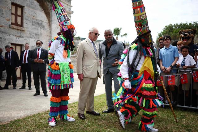 Britain's King Charles III watches Gombey dancers performance during a cultural welcome at the Royal Naval Dockyard, Sandys Parish, Bermuda on May 1, 2026. King Charles III is in Bermuda for his first visit to a British Overseas Territory as Sovereign. (Photo by HENRY NICHOLLS / AFP)