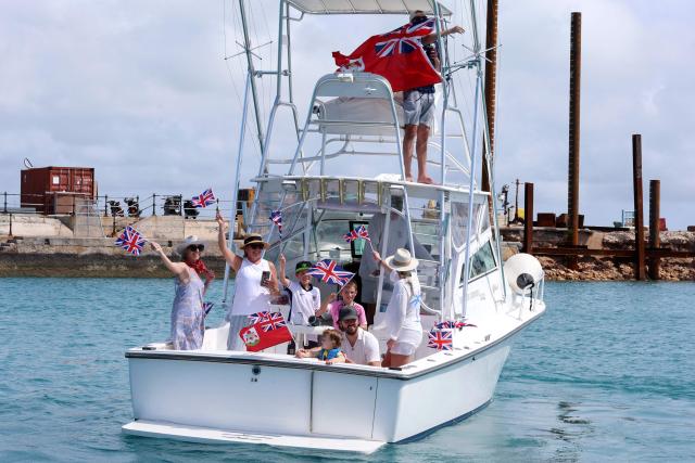 Members of the public await the arrival of King Charles III ahead of a Coast Guard briefing on May 1, 2026 in Hamilton, Bermuda. King Charles III is in Bermuda for his first visit to a British Overseas Territory as Sovereign. (Photo by Chris Jackson / POOL / AFP)