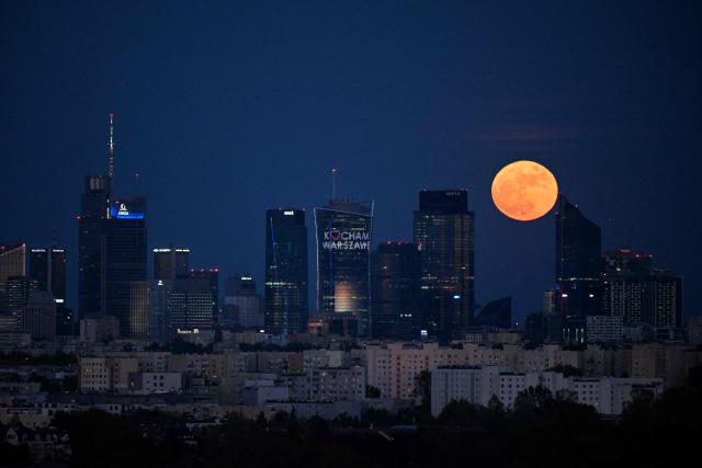The full moon also known as the Flower Moon rises above Warsaw's skyscrapers as seen from the village of Klaudyn, Masovian Voivodeship on May 1, 2026. (Photo by Sergei GAPON / AFP)
