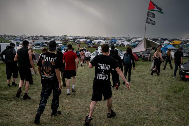 Revellers take part in a Rave Party at a military site in Cornusse, near Bourges, central France on May 1, 2026. Around 20,000 partygoers gathered on May 1, 2026, at a military site near Bourges – described by the authorities as "extremely dangerous" – to take part in a rave party, against a backdrop of tougher legislation targeting these illegal techno gatherings. (Photo by ARNAUD FINISTRE / AFP)