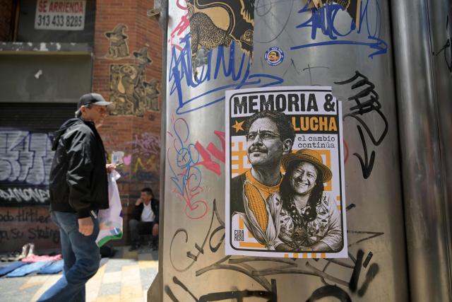 A man walks past a propaganda poster pasted to a pole showing Colombias ruling party Pacto Historico presidential candidate Ivan Cepeda during a May Day rally marking International Workers Day, in Bogota, on May 1, 2026 (Photo by Raul ARBOLEDA / AFP)