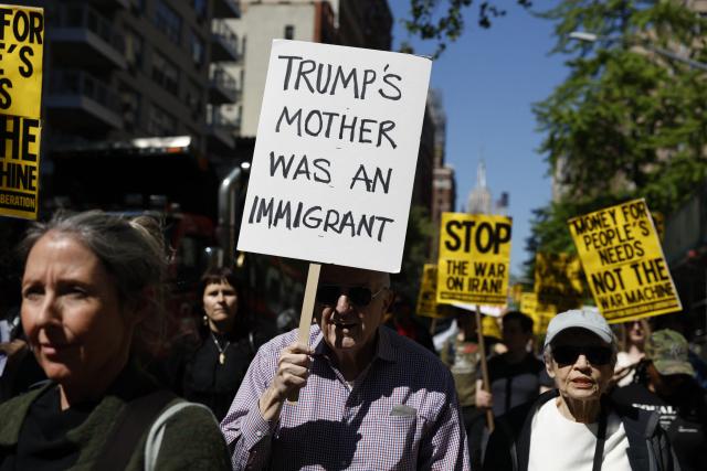 People march holding signs during a May Day rally marking International Workers' Day in New York, on May 1, 2026. (Photo by Kena Betancur / AFP)