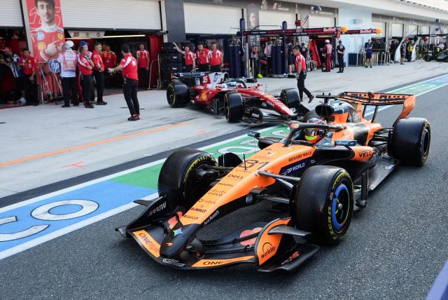 (L/R) Ferrari's Monegasque driver Charles Leclerc and McLaren's Australian driver Oscar Piastri leave their garages in pit lane during Sprint qualifying ahead of the 2026 Miami Formula One Grand Prix at Miami International Autodrome in Miami Gardens, Florida, on May 1, 2026. (Photo by Lynne Sladky / POOL / AFP)