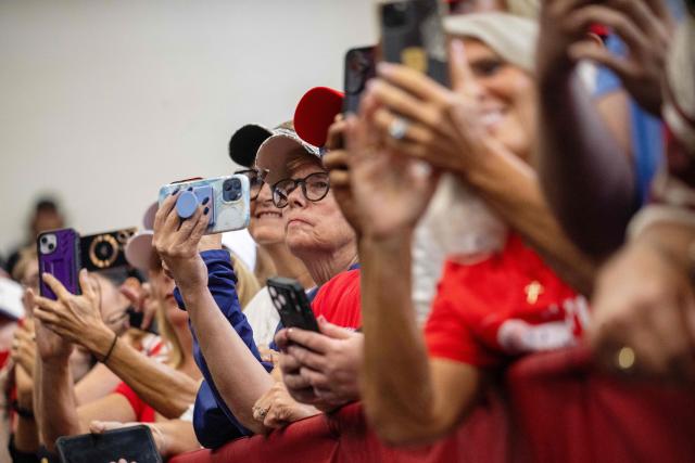 Attendees react as US President Donald Trump arrives to give a speech about taxes and Social Security in The Villages, Florida, on May 1, 2026. (Photo by Jim WATSON / AFP)