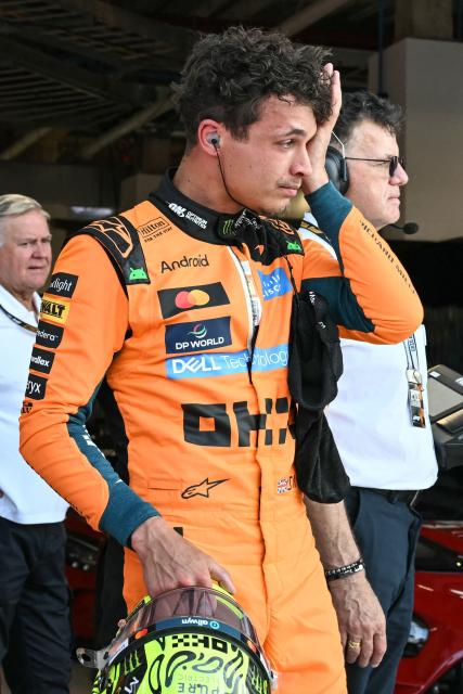 McLaren's British driver Lando Norris exits his car after finishing in the pole position during Sprint qualifying ahead of the 2026 Miami Formula One Grand Prix at Miami International Autodrome in Miami Gardens, Florida, on May 1, 2026. (Photo by CHANDAN KHANNA / AFP)