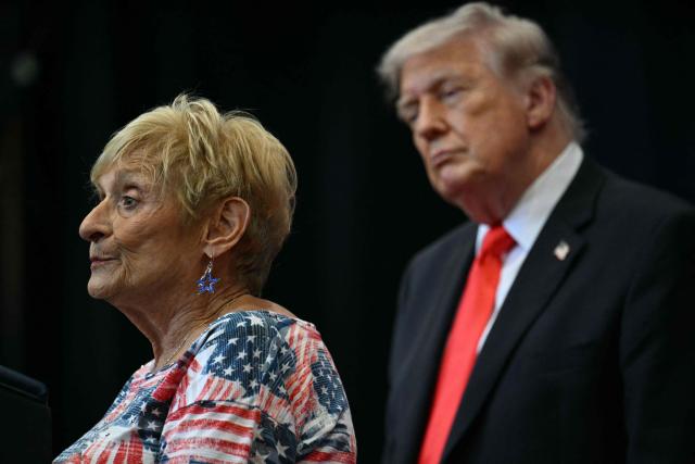 US President Donald Trump listens to a supporter during an event where he spoke about taxes and Social Security in The Villages, Florida, on May 1, 2026. (Photo by Jim WATSON / AFP)
