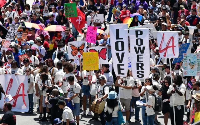 People march during a May Day rally marking International Workers' Day in Los Angeles, on May 1, 2026. (Photo by Frederic J. BROWN / AFP)