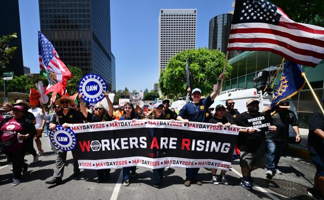 People march during a May Day rally marking International Workers' Day in Los Angeles, on May 1, 2026. (Photo by Frederic J. BROWN / AFP)