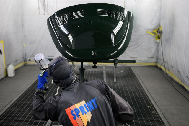 A worker paints chassis components of a Fiat 500 model that will be transformed into an electric 500 Jolly Lido model at the Officine Gentile garage in Turin on April 30, 2026. In the Officine Gentile workshop in Turin -- the historic home of Italian carmaker Fiat -- vintage 500 models are getting a makeover with electric engines. The original Fiat 500 became a design icon and some 4.2 million models were made. The retrofitted cars sell for around 40-50,000 euros with convertibles for up to 80,000 euros. (Photo by MARCO BERTORELLO / AFP)
