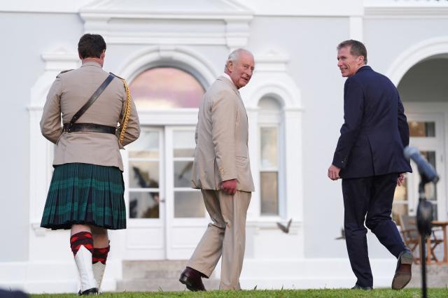 Britain's King Charles III leaves accompanied by the Governor of Bermuda Andrew Murdoch (R) at the end of a garden party at the Government House in Hamilton, Bermuda, on May 1, 2026. King Charles III is in Bermuda for his first visit to a British Overseas Territory as Sovereign. (Photo by Yui Mok / POOL / AFP)