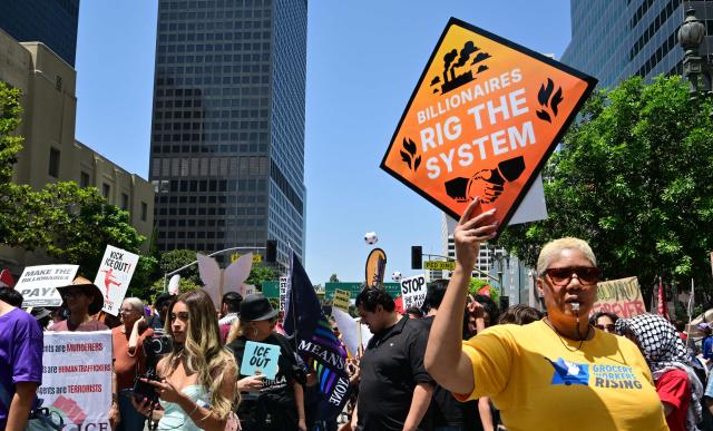 People march during a May Day rally marking International Workers' Day in Los Angeles, on May 1, 2026. (Photo by Frederic J. BROWN / AFP)