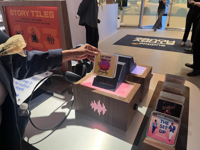 A customer shops at the Audible Story House in New York, on April 30, 2026. The pop-up store labeled as a "bookless bookstore" is dedicated to audiobooks. (Photo by Thomas URBAIN / AFP)
