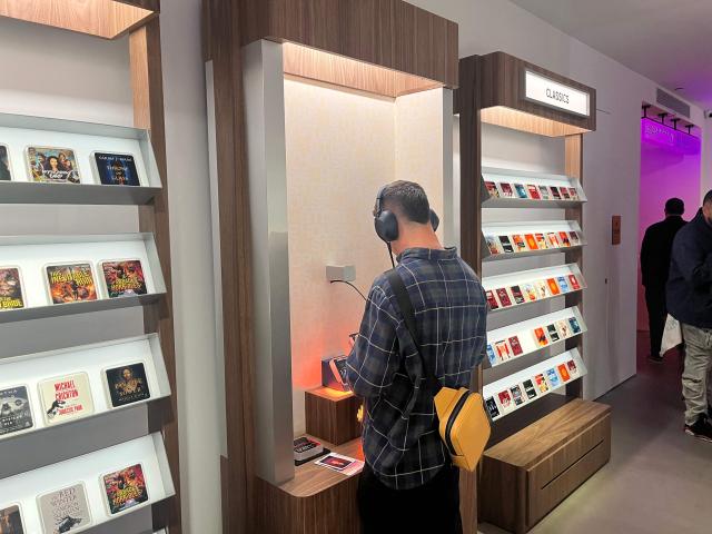 A customer shops at the Audible Story House in New York, on April 30, 2026. The pop-up store labeled as a "bookless bookstore" is dedicated to audiobooks. (Photo by Thomas URBAIN / AFP)