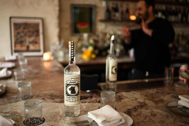 A bottle of the traditional Iranian spirit "Aragh Sagi" produced in Yonkers, New York, is seen at a restaurant in the Brooklyn borough of New York City, on April 28, 2026. Three Iranian men pressed rehydrated raisins at an artisan distillery just outside New York, thousands of miles from their war-struck homeland. They were carefully producing aragh sagi, a traditional spirit banned by the clerical authorities along with all alcohol following the 1979 Islamic revolution. Despite its outlaw moonshine status, the drink is still made clandestinely and consumed inside Iran. (Photo by CHARLY TRIBALLEAU / AFP)