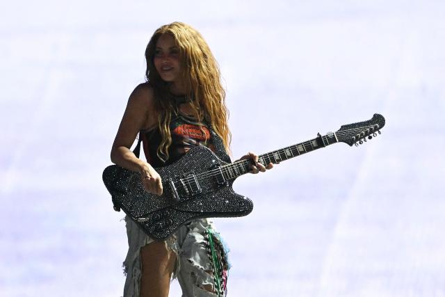 Colombian singer Shakira plays the guitar on stage during a rehearsal at Copacabana Beach in Rio de Janeiro, Brazil, on May 1, 2026. The Colombian singer is scheduled to perform on May 2. (Photo by Mauro PIMENTEL / AFP)