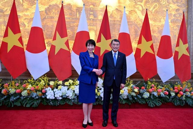 Vietnam's Prime Minister Le Minh Hung (R) shakes hands with Japan's Prime Minister Sanae Takaichi at the government office in Hanoi on May 2, 2026. (Photo by Nhac NGUYEN / POOL / AFP)