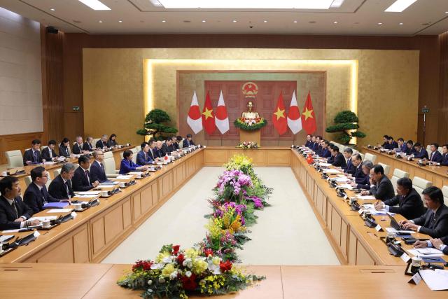 Japan's Prime Minister Sanae Takaichi (centre L) and her delegation attends a meeting with Vietnam's Prime Minister Le Minh Hung (centre R) in Hanoi on May 2, 2026. (Photo by Hoang Long / AFP)