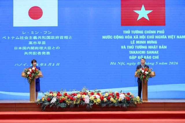 Japan's Prime Minister Sanae Takaichi (L) and Vietnam's Prime Minister Le Minh Hung take part in a joint press conference in Hanoi on May 2, 2026. (Photo by Hoang Long / AFP)