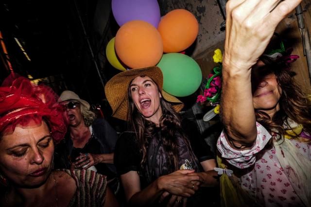 Revelers participate at the traditional "Santa Capelina" festival in Nice, south-eastern France, on May 1, 2026. Revelers gather on May 1 in Nice to celebrate the annual Santa Capelina, parading in hand-made hats and sharing a fish soup cooked on site, with each participant contributing their own fish. A Santa figure, built collectively from branches and flowers with a papier-mâché head, is carried in a procession to the beach before casting it into the sea. (Photo by Valery HACHE / AFP)