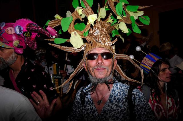 Revelers participate at the traditional "Santa Capelina" festival in Nice, south-eastern France, on May 1, 2026. Revelers gather on May 1 in Nice to celebrate the annual Santa Capelina, parading in hand-made hats and sharing a fish soup cooked on site, with each participant contributing their own fish. A Santa figure, built collectively from branches and flowers with a papier-mâché head, is carried in a procession to the beach before casting it into the sea. (Photo by Valery HACHE / AFP)