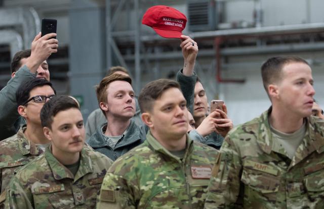 (FILES) A member of the US military holds up a "Make America Great Again" hat as US President Donald Trump and First Lady Melania Trump greet members of the US military during a stop at Ramstein Air Base in Germany, on December 27, 2018. Germany's defence minister on May 2, 2026, said the withdrawal of American troops from Germany had been expected and that Europe needed to do more to ensure its own security. The Pentagon on May 1, announced the withdrawal of about 5,000 troops from Germany within the next year, the latest rift in transatlantic ties over the Mideast war. (Photo by SAUL LOEB / AFP)