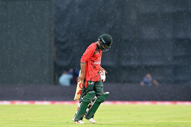 Bangladesh's Towhid Hridoy walks back to the pavilion as rain halts play during the third T20 cricket match between Bangladesh and New Zealand at the Sher-e-Bangla National Stadium in Mirpur on May 2, 2026. (Photo by Munir UZ ZAMAN / AFP)
