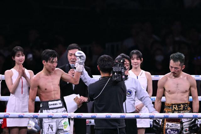 Toshiki Shimomachi (2nd L) celebrates beating Reiya Abe (R) in their Featherweight undercard boxing contest at Tokyo Dome in Tokyo on May 2, 2026. (Photo by Yuichi YAMAZAKI / AFP)