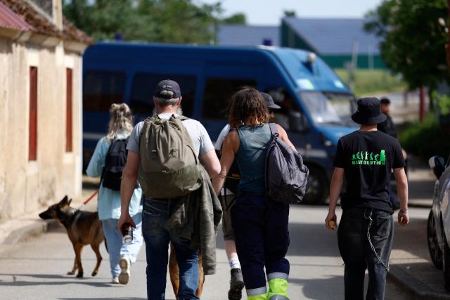 Revellers arrive to attend a free-party at a military site in Cornusse, near Bourges, central France on May 2, 2026. A free party bringing together around 20,000 partygoers began on May 1, 2026, on a military site near Bourges, described as "very dangerous" by the authorities, in a context of stricter legislation against these illegal techno gatherings. (Photo by Kenzo TRIBOUILLARD / AFP)