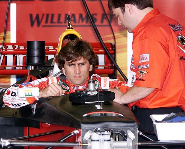 (FILES) Italian Formula One driver Alex Zanardi(L) sits in the cockpit of his Williams-Winfield, 08 April 1999, at the pits of the Interlagos race track in Sao Paulo, Brazil. Alex Zanardi, the Italian racing car driver who became a Paralympic cycling champion after losing both legs in an accident, has died aged 59, his family announced on May 2, 2026. Zanardi, one of his country's most loved and respected sportsmen, who as credited with helping transformed the perception of disability in Italy, died on the evening of May 1. (Photo by ANTONIO SCORZA / AFP)