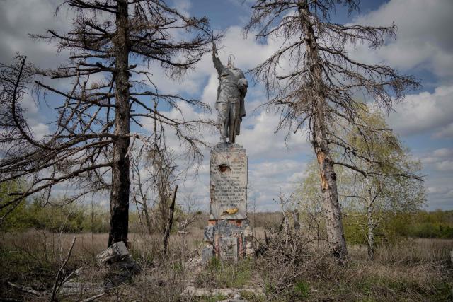 This photograph shows a monument to a Soviet soldier, damaged during battles for the village in 2022, in the village of Dovhenke, Kharkiv region, on May 1, 2026, amid the Russian invasion of Ukraine. (Photo by Ivan SAMOILOV / AFP)