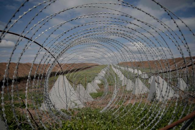 This photograph shows dragon's teeth, pyramidal anti-tank obstacles of reinforced concrete, and a barbed wire defence line at an undisclosed location in the Kharkiv region, eastern Ukraine, on May 1, 2026, amid the Russian invasion of Ukraine. (Photo by Ivan SAMOILOV / AFP)