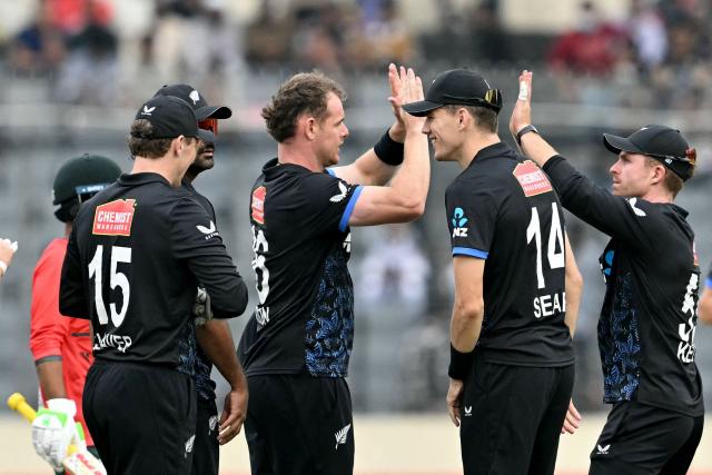 New Zealand's Josh Clarkson (C) celebrates with teammates after taking the wicket of Bangladesh's captain Litton Das during the third T20 cricket match between Bangladesh and New Zealand at the Sher-e-Bangla National Stadium in Mirpur on May 2, 2026. (Photo by Munir UZ ZAMAN / AFP)