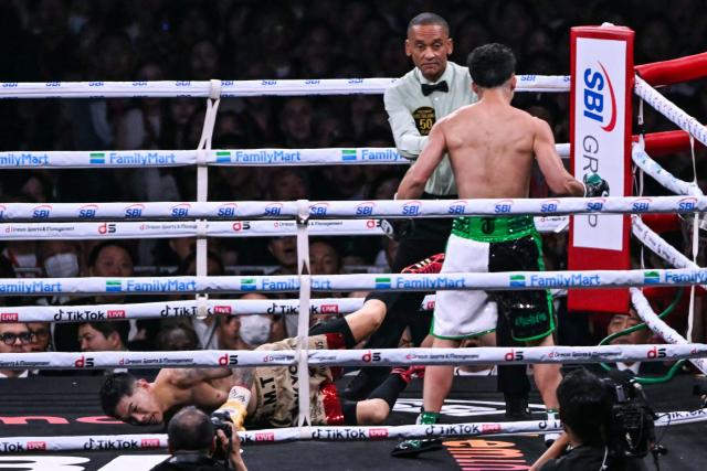 Kazuto Ioka (L) falls to the mat after being knocked down by Takuma Inoue during their WBC Bantamweight Title Match boxing contest at Tokyo Dome in Tokyo on May 2, 2026. (Photo by Yuichi YAMAZAKI / AFP)