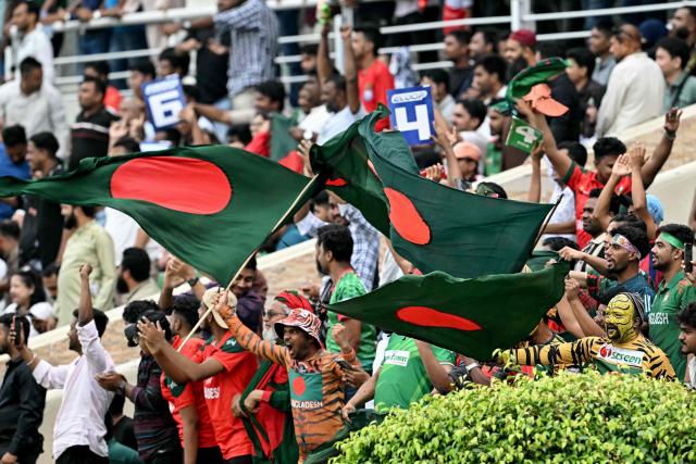 Fans wave Bangladesh's national flag during the third T20 cricket match between Bangladesh and New Zealand at the Sher-e-Bangla National Stadium in Mirpur on May 2, 2026. (Photo by Munir UZ ZAMAN / AFP)